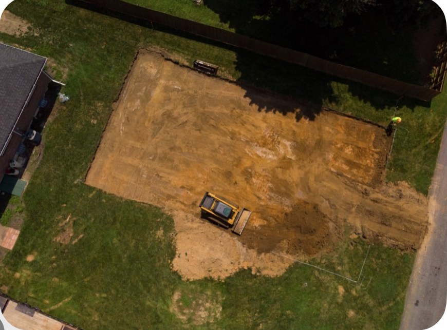 Aerial view of a squared foundation excavation with a dozer working the pad in Northampton, PA